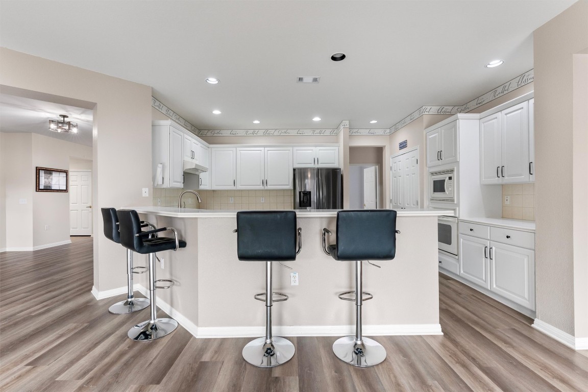 122 Nolan Drive Georgetown, TX 78633 - Photo 12 of 35 a kitchen with stainless steel appliances kitchen island refrigerator and cabinets