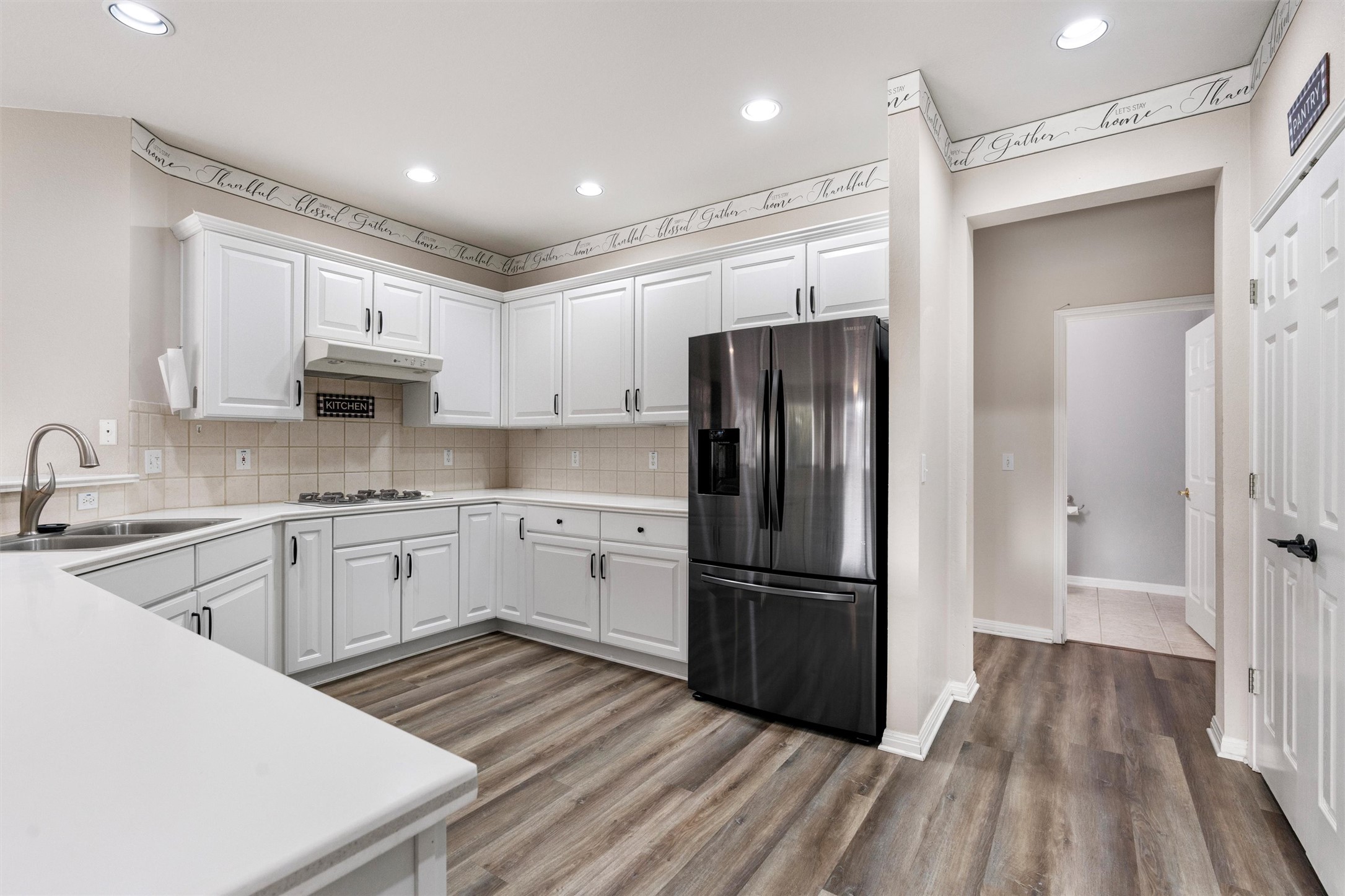 122 Nolan Drive Georgetown, TX 78633 - Photo 13 of 35 a kitchen with granite countertop a refrigerator stove and sink