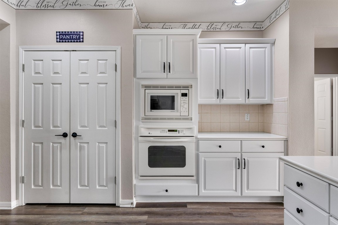 122 Nolan Drive Georgetown, TX 78633 - Photo 16 of 35 a kitchen with white cabinets and white appliances