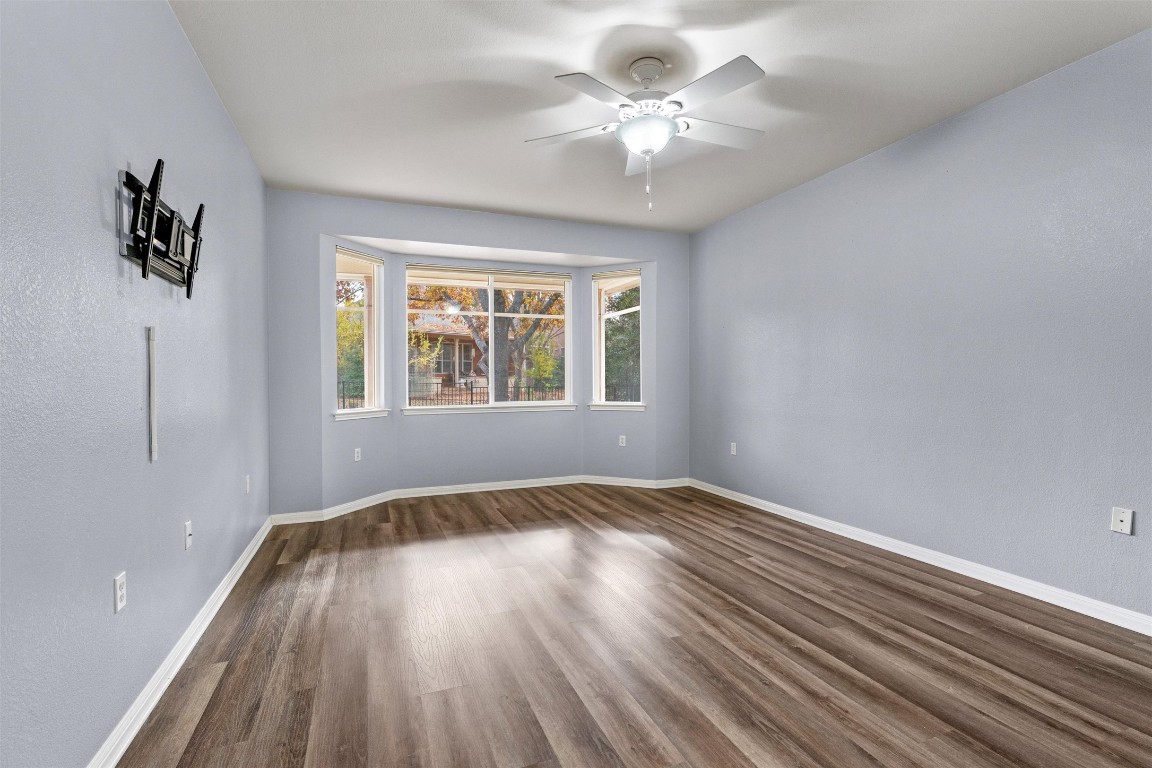 122 Nolan Drive Georgetown, TX 78633 - Photo 17 of 35 a view of an empty room with a window and wooden floor