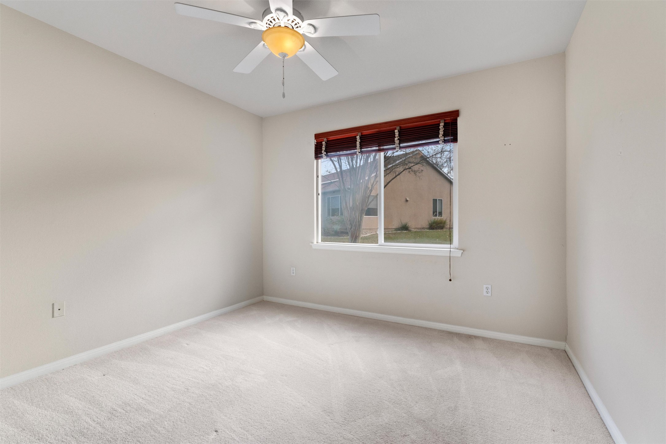 122 Nolan Drive Georgetown, TX 78633 - Photo 22 of 35 an empty room with a chandelier fan and windows