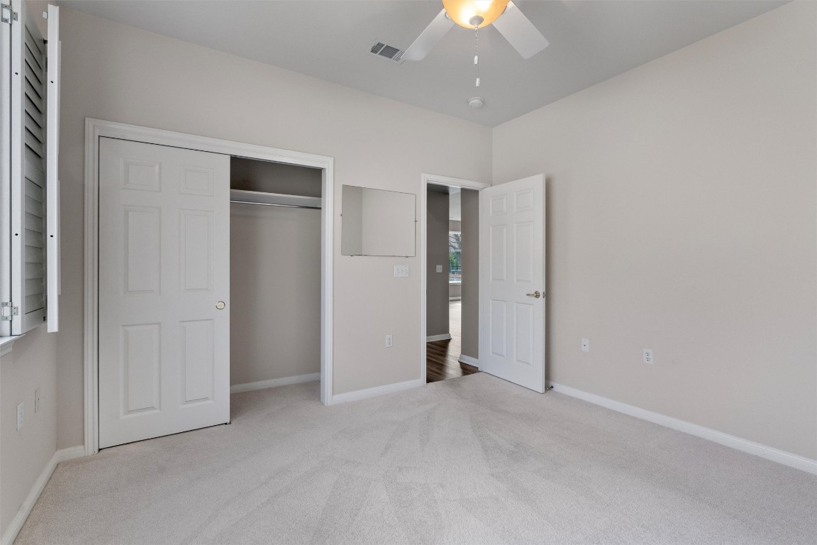 122 Nolan Drive Georgetown, TX 78633 - Photo 26 of 35 an empty room with an entryway and chandelier fan