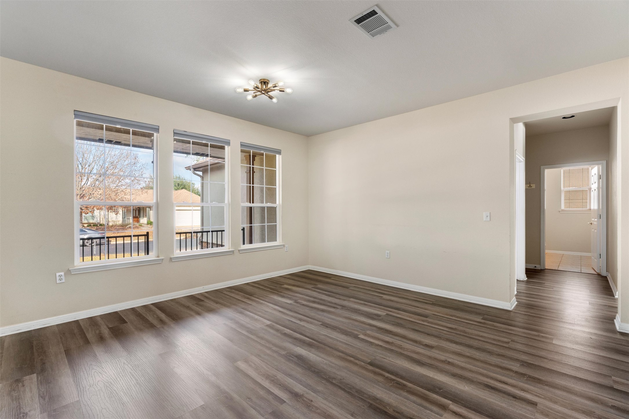 122 Nolan Drive Georgetown, TX 78633 - Photo 4 of 35 a view of an empty room with wooden floor and a window