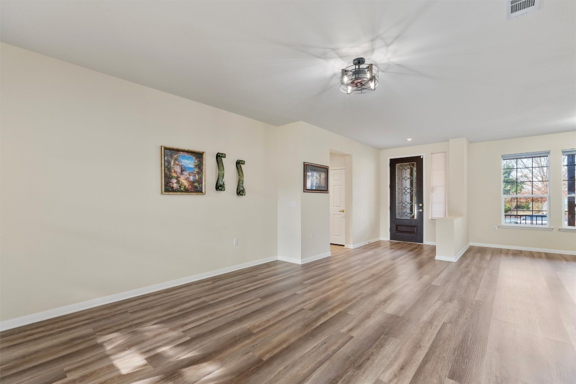 122 Nolan Drive Georgetown, TX 78633 - Photo 7 of 35 a view of an empty room with a window and wooden floor