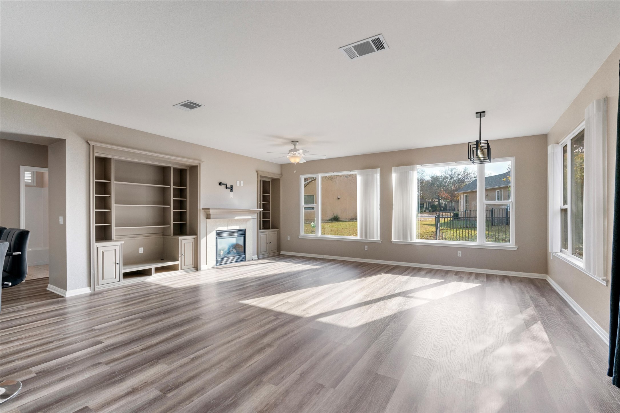 122 Nolan Drive Georgetown, TX 78633 - Photo 8 of 35 a view of an empty room with wooden floor and a window