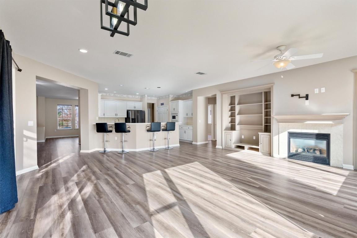 122 Nolan Drive Georgetown, TX 78633 - Photo 10 of 35 a spacious bedroom with a large bed and a chandelier