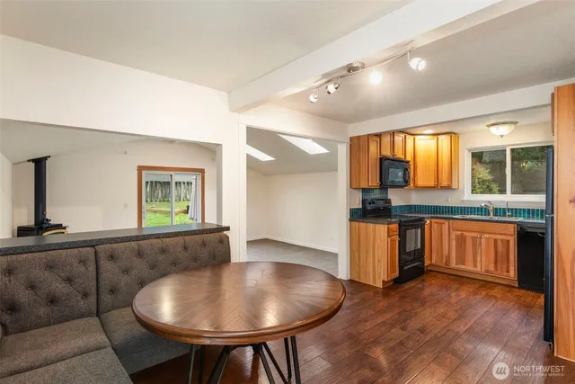 a living room with sink and furniture with wooden floor