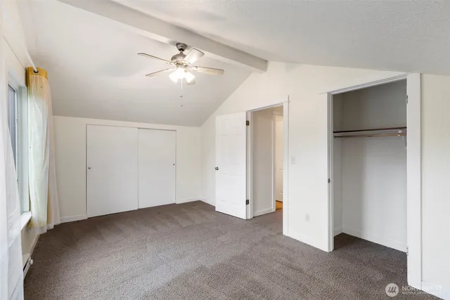 a view of a big room with chandelier fan and a chandelier fan