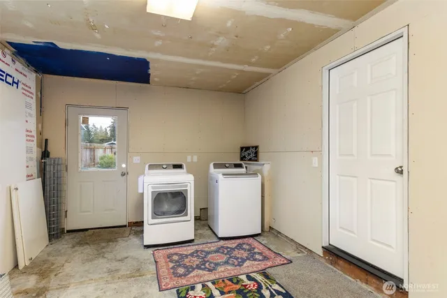 a utility room with sink dryer and washer