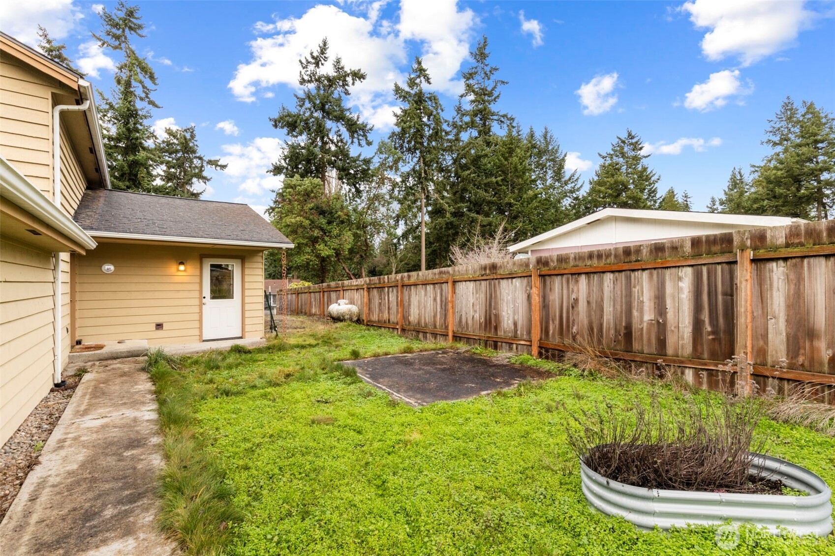 101 D Street Port Hadlock, WA 98339 - Photo 27 of 36 a view of a backyard with plants and a patio