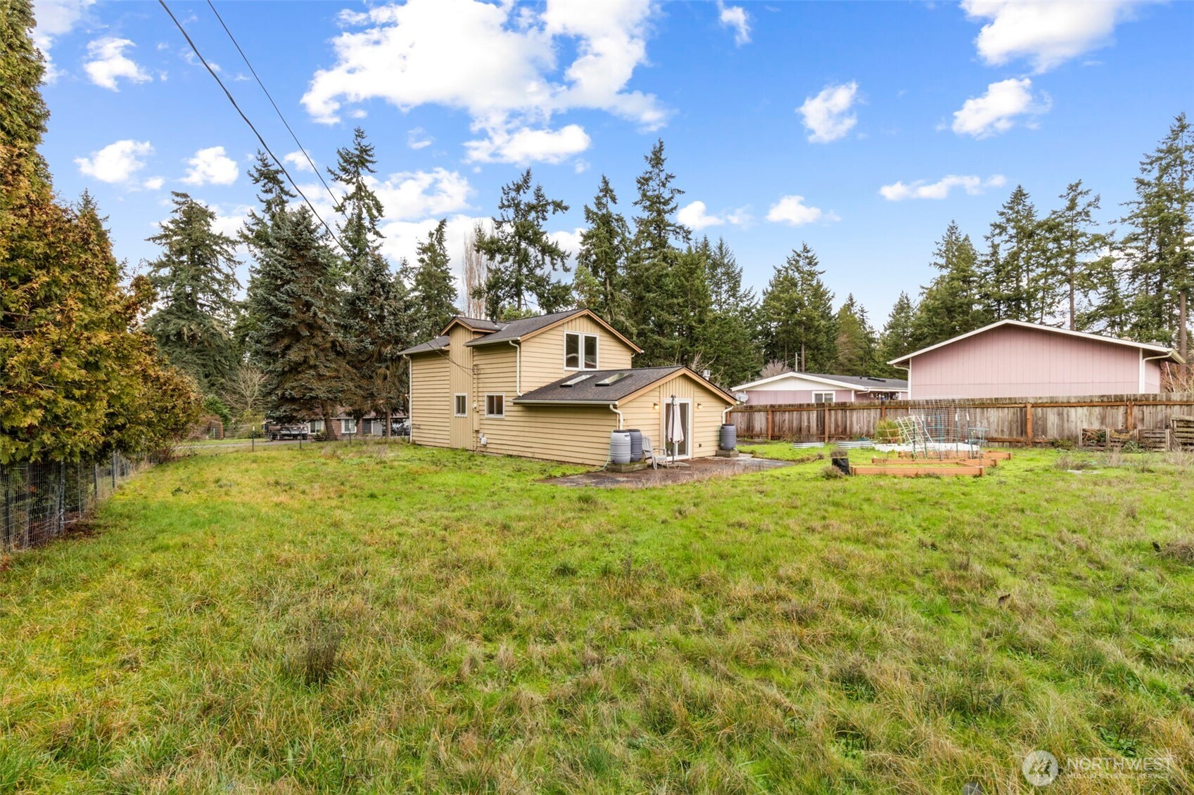 101 D Street Port Hadlock, WA 98339 - Photo 30 of 36 a view of a big house with table and chairs under an umbrella