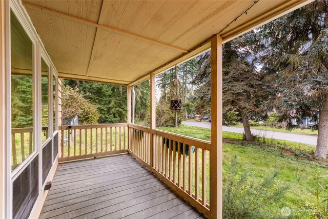 a view of a porch with wooden floor and fence