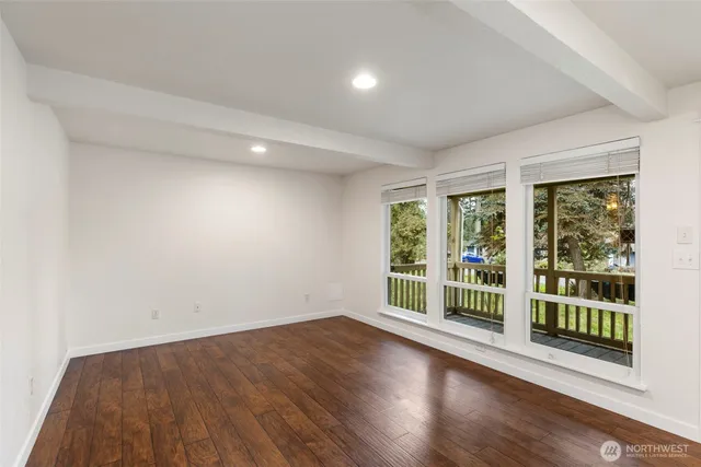 a view of wooden floor and windows in a room