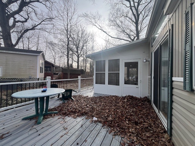 2795 East 28th Road Marseilles, IL 61341 - Photo 19 of 23 a view of a roof deck with table and chairs a barbeque with wooden floor and fence