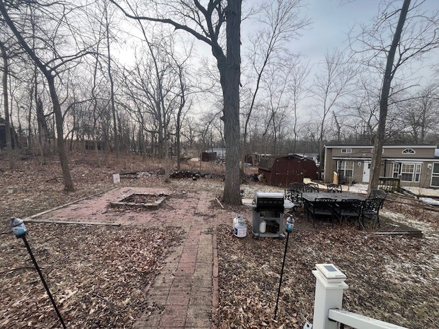 2795 East 28th Road Marseilles, IL 61341 - Photo 22 of 23 a backyard of a house with barbeque oven and outdoor seating
