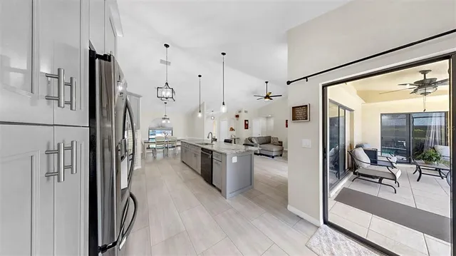 a large white kitchen with stainless steel appliances