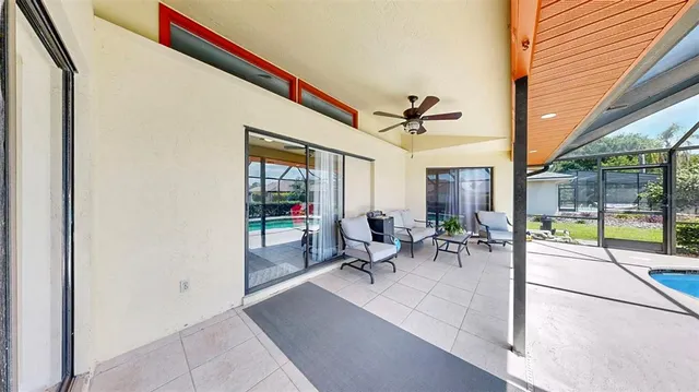 a view of a porch with chairs and backyard