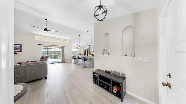 a living room with furniture a window and a chandelier
