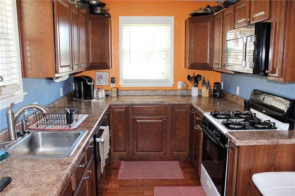 1412 Brinton Road Pittsburgh, PA 15221 - Photo 4 of 25 Updated kitchen with a gas stove, microwave, and plenty of space to work.