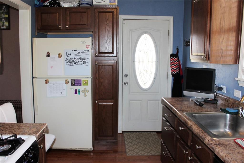 1412 Brinton Road Pittsburgh, PA 15221 - Photo 6 of 25 Entry into kitchen with some hooks for coats. Fridge stays.