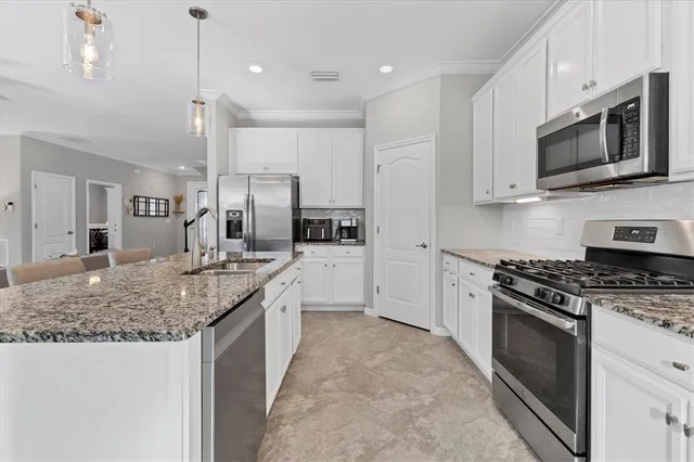a view of a dining room with furniture and chandelier