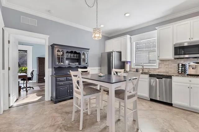 a view of a house with a yard and potted plants
