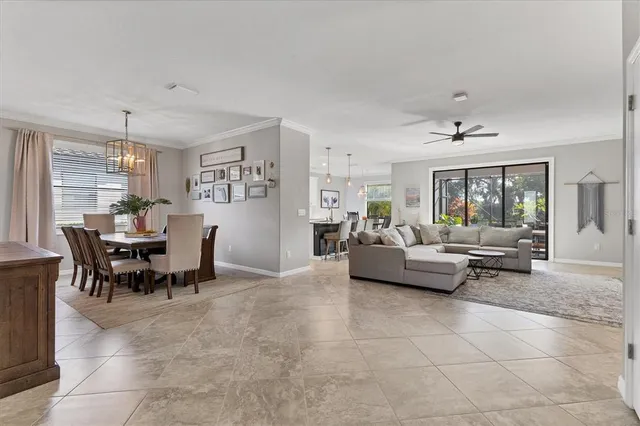 a kitchen with stainless steel appliances granite countertop a stove a sink a microwave a refrigerator and white cabinets with wooden floors