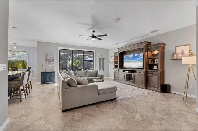 a kitchen with stainless steel appliances granite countertop a stove a sink a dining table and chairs with wooden floor