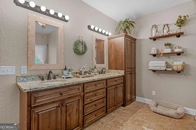 a bathroom with a double vanity sink and a mirror
