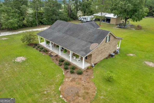 a aerial view of a house with a yard