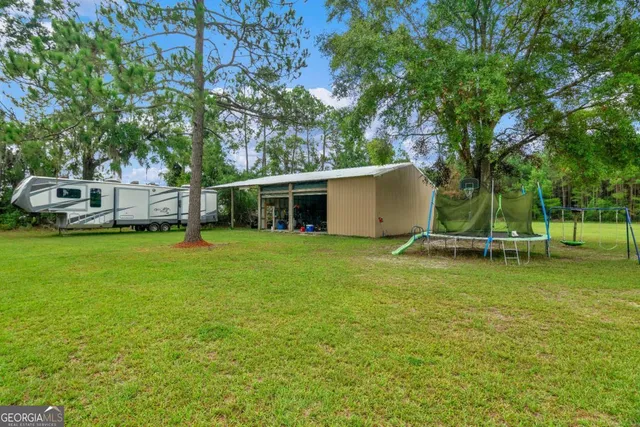 a front view of a house with swimming pool having outdoor seating