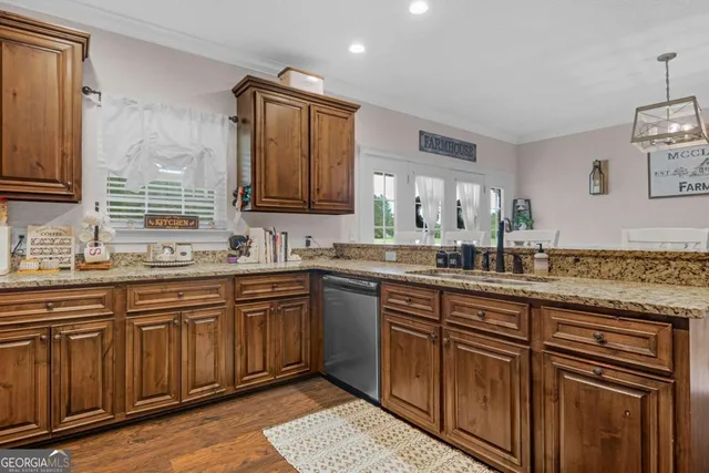 a kitchen with granite countertop a sink and cabinets