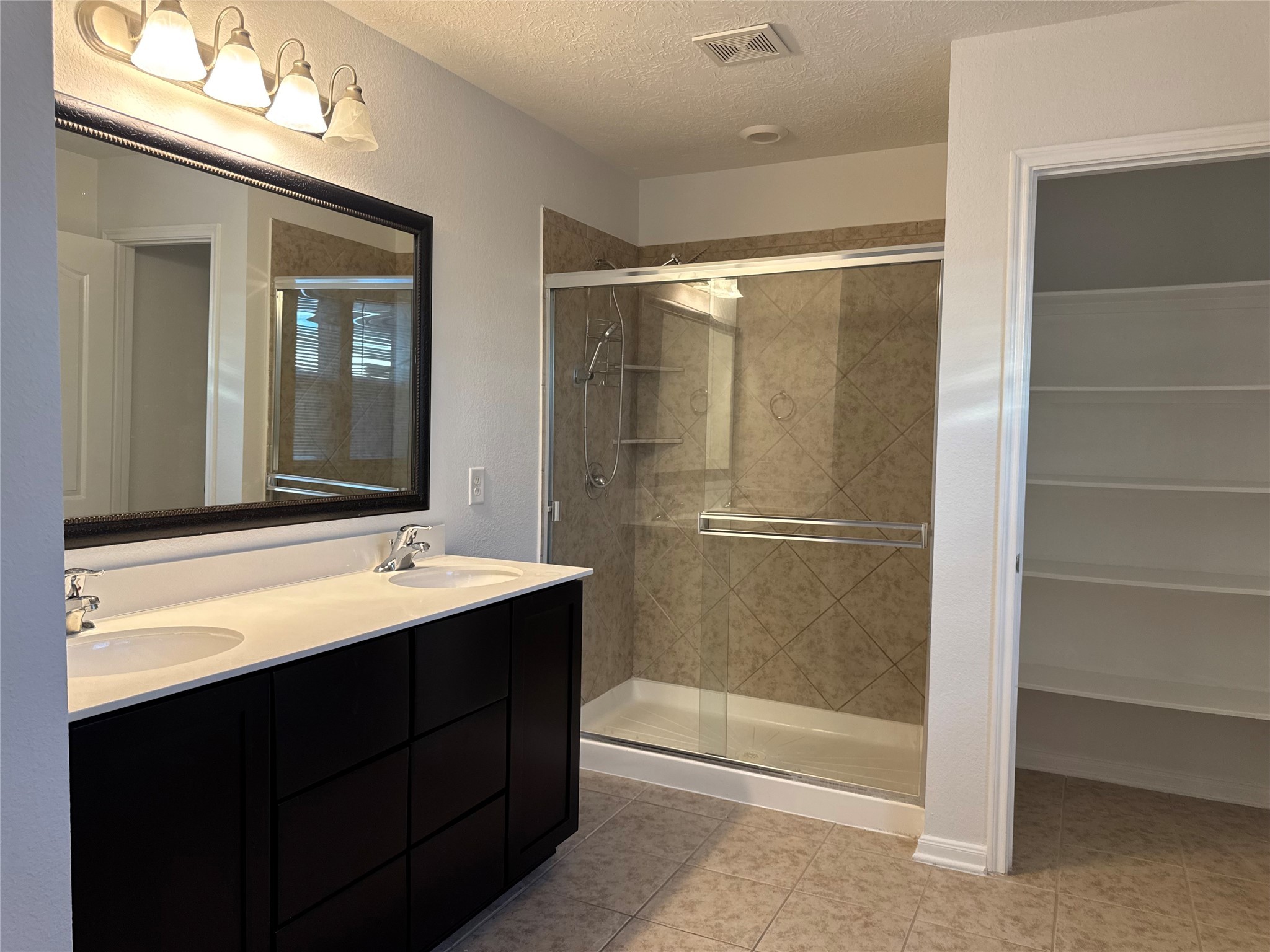 15815 Copper Oak Lane Houston, TX 77084 - Photo 16 of 33 a bathroom with a double vanity sink mirror and shower