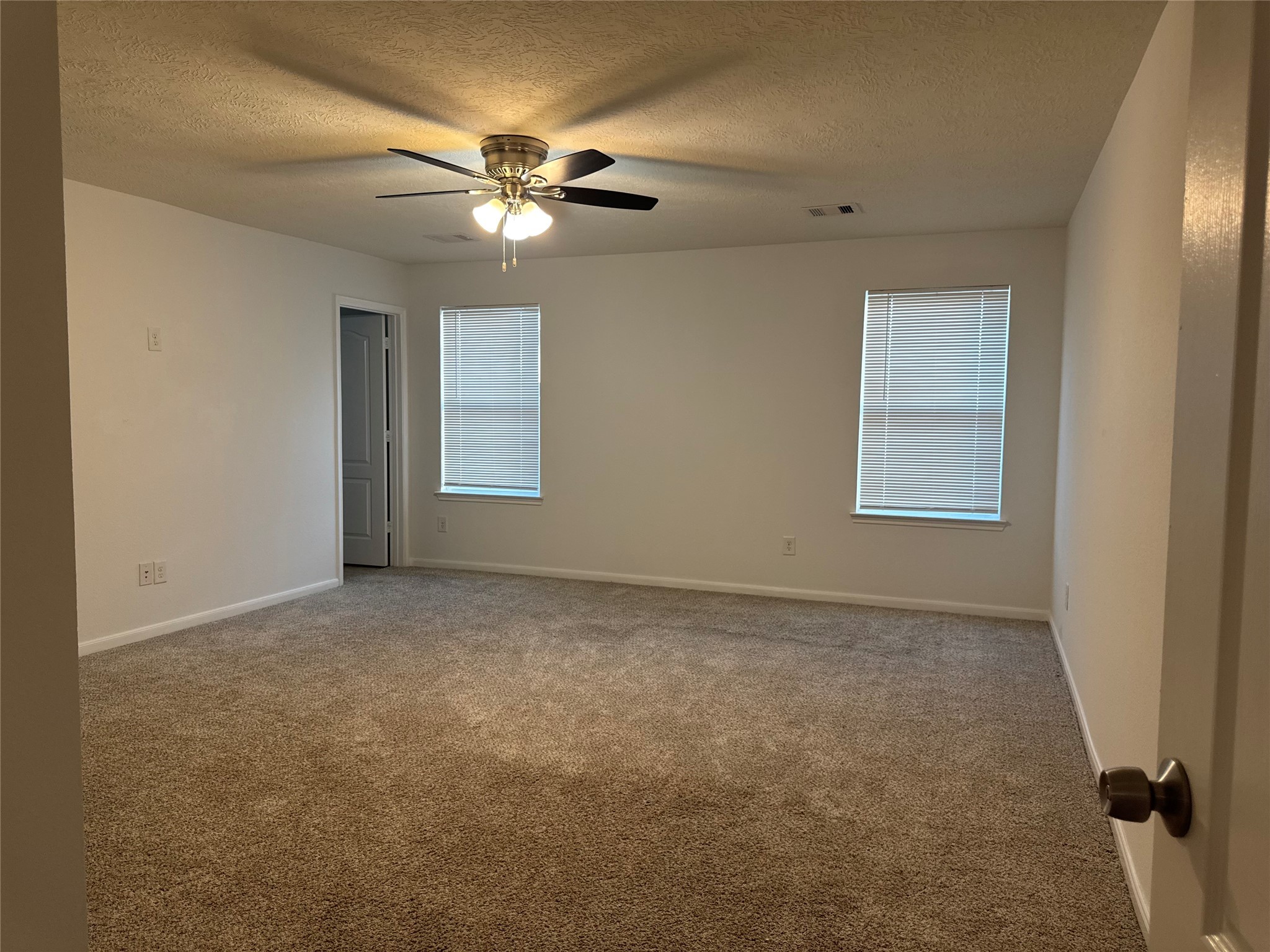 15815 Copper Oak Lane Houston, TX 77084 - Photo 19 of 33 an empty room with windows and fan