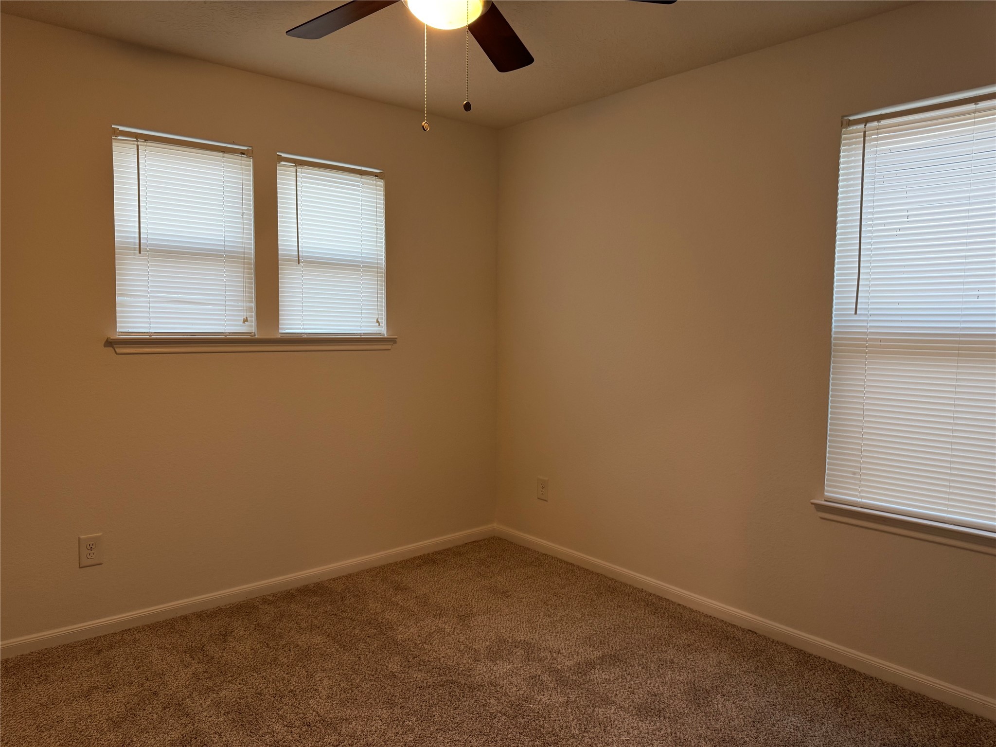 15815 Copper Oak Lane Houston, TX 77084 - Photo 26 of 33 an empty room with a window and a chandelier fan