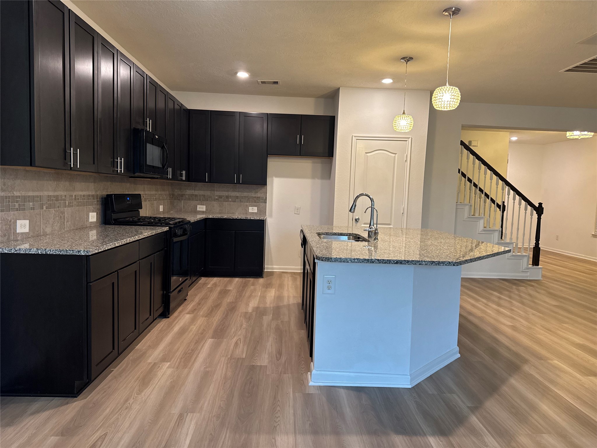 15815 Copper Oak Lane Houston, TX 77084 - Photo 6 of 33 a kitchen with stainless steel appliances granite countertop a sink a stove and a refrigerator