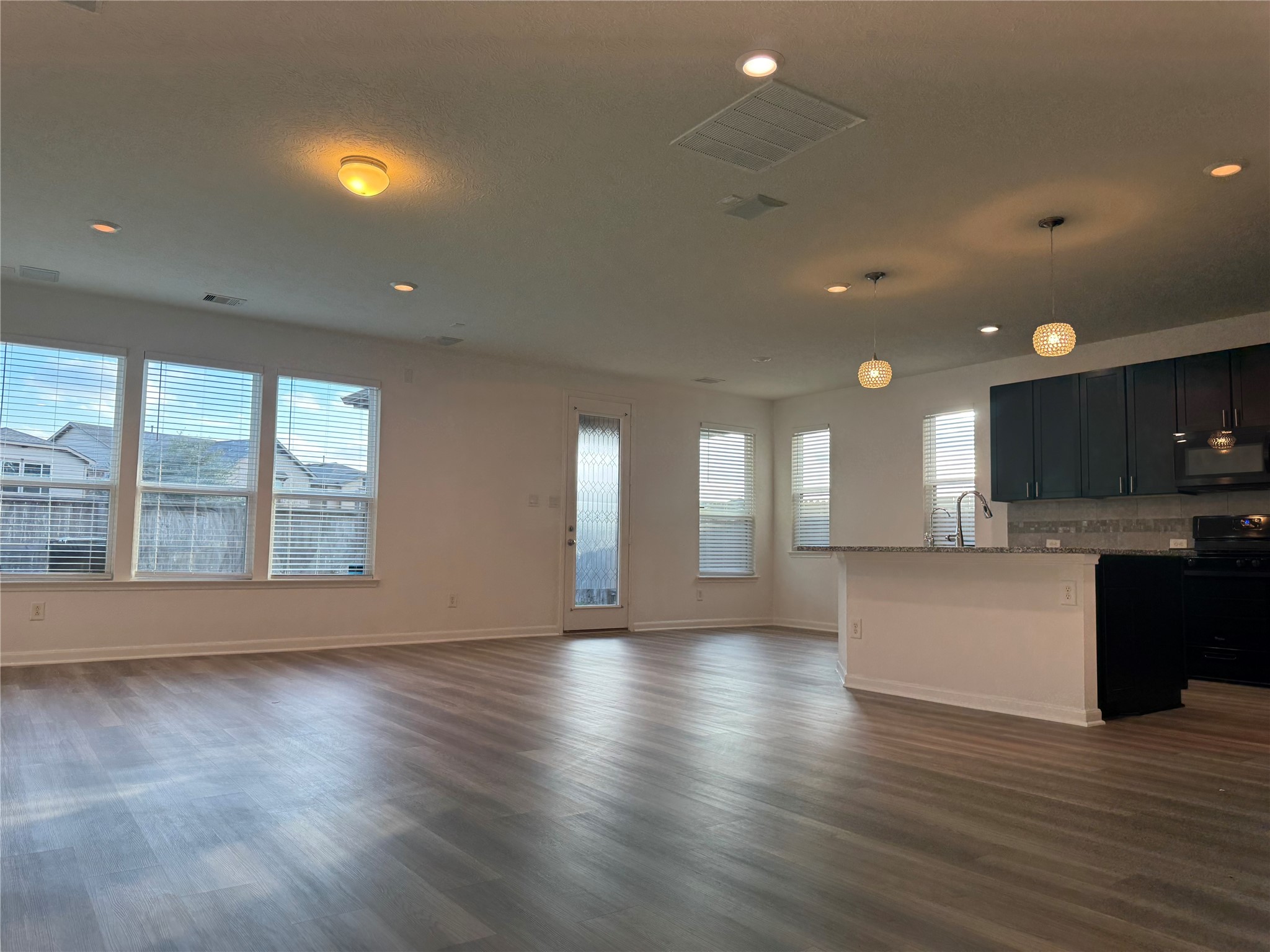 15815 Copper Oak Lane Houston, TX 77084 - Photo 7 of 33 a view of an empty room with wooden floor and a window