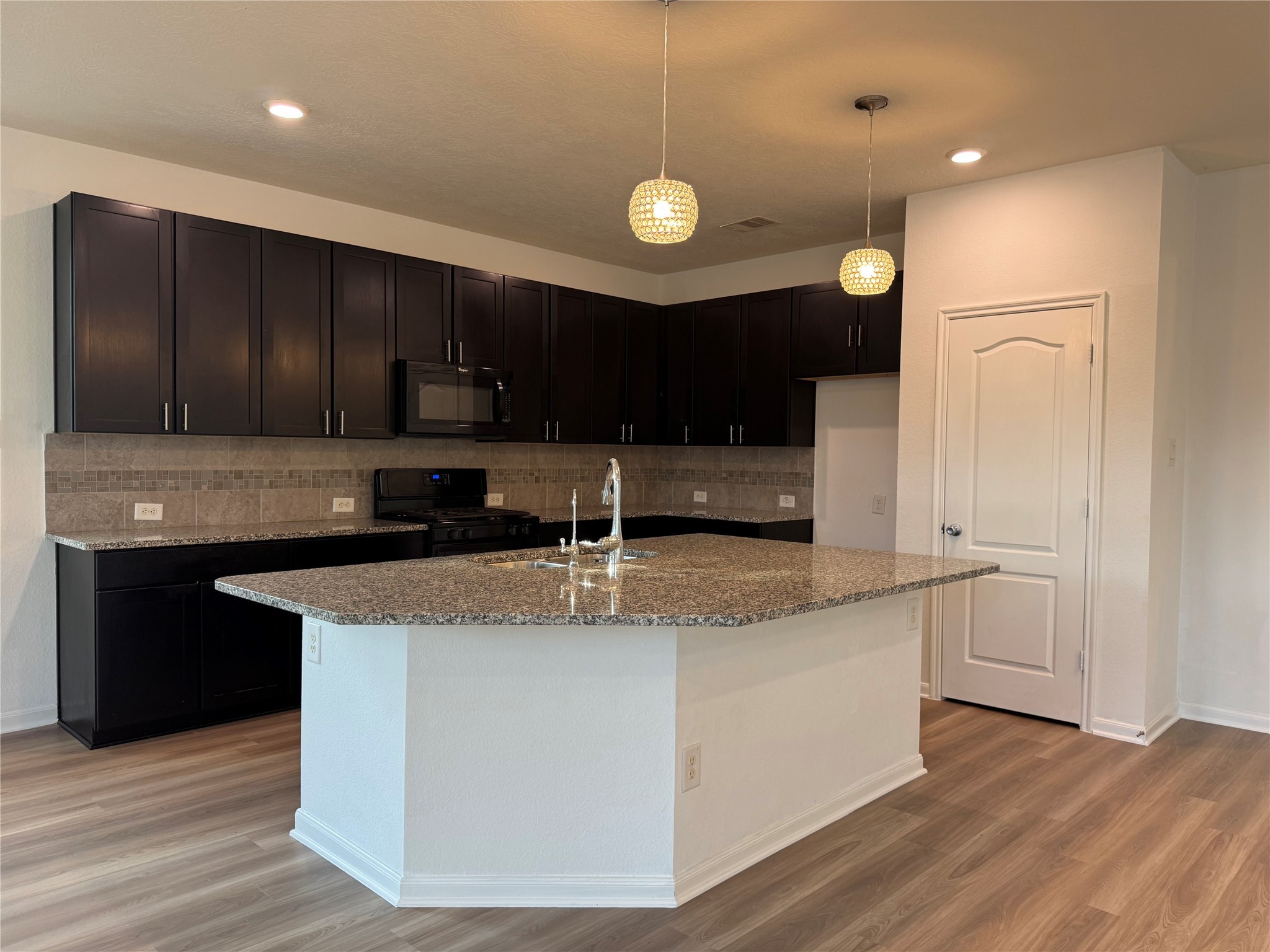 15815 Copper Oak Lane Houston, TX 77084 - Photo 8 of 33 a kitchen with stainless steel appliances granite countertop a sink a stove and a refrigerator