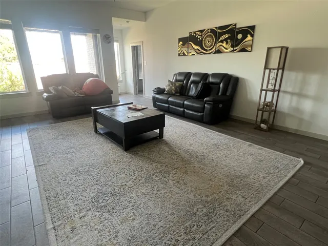 a living room with furniture and a rug