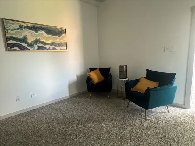 a living room with furniture and a rug