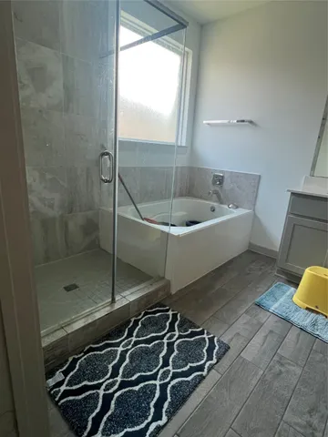 a bathroom with a bathtub and a shower
