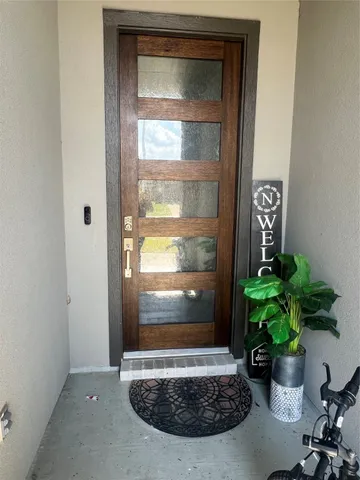 a view of a glass door with a potted plant