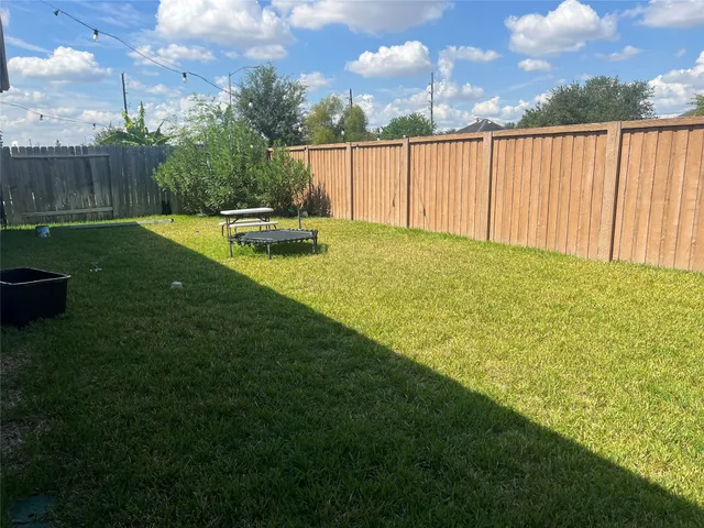 a backyard of a house with table and chairs