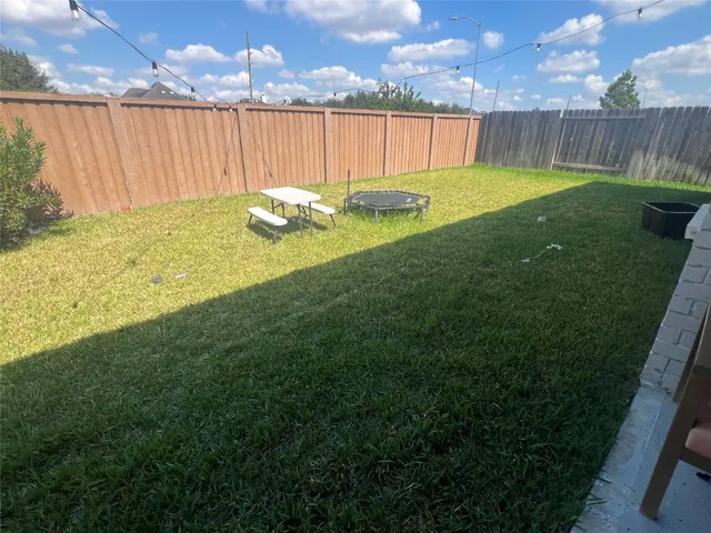 a backyard of a house with yard fire pit table and chairs
