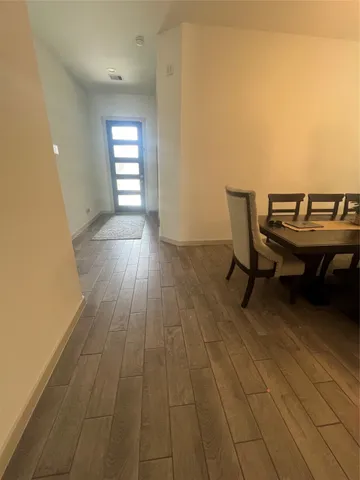 a view of a workspace with wooden floor