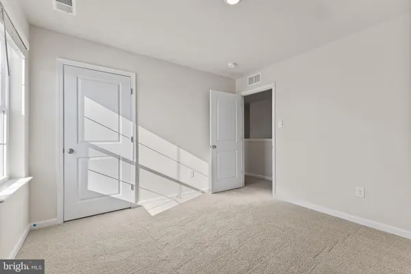 an empty room with closet area