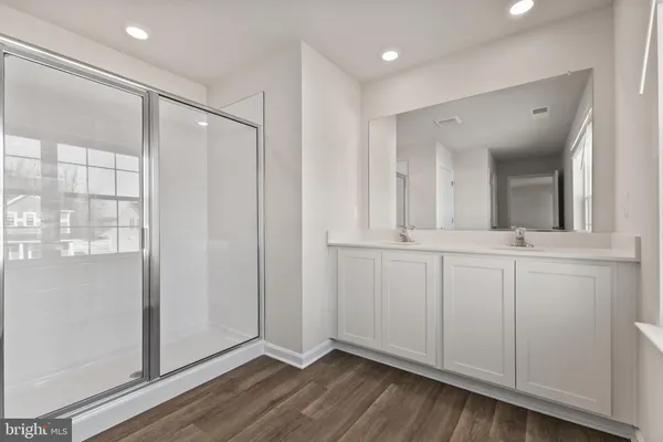 a bathroom with a mirror and a shower