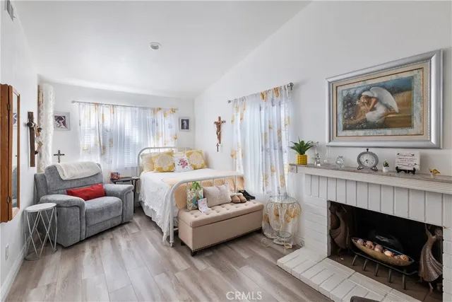 a bedroom with furniture and a fireplace