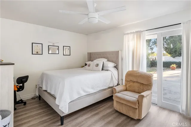 a bedroom with bed and a large window