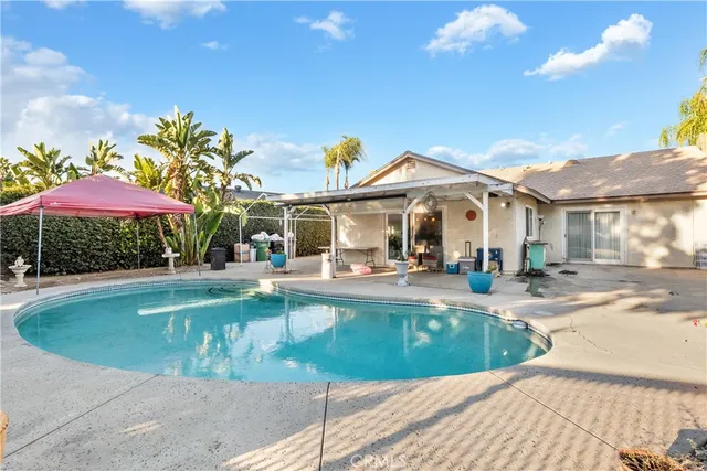 a view of a house with swimming pool and sitting area